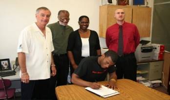 From right, Newton Chelette, Harley's parents, Harley and Holy Names Coach Dennis Jones